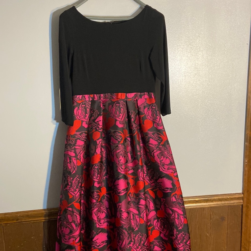 A line gown. Plain black top, pink, red  flower bottom